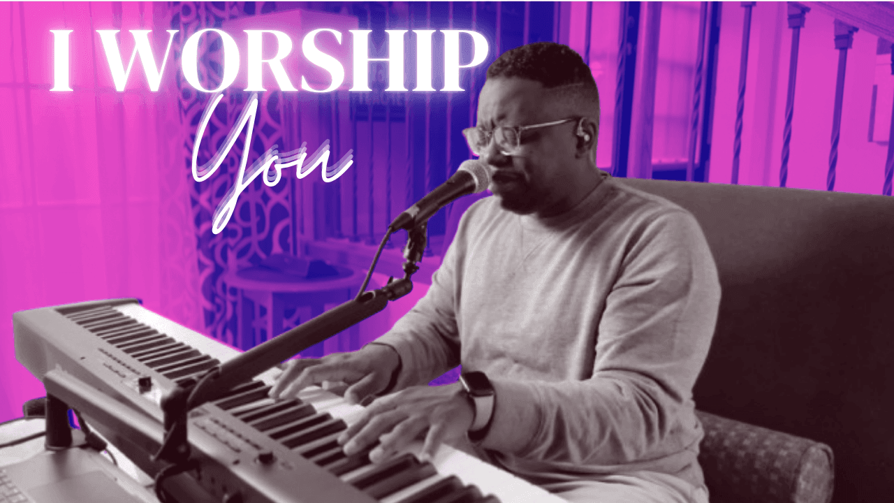 Individual playing a keyboard and singing into a microphone with the text 'I Worship You' displayed.